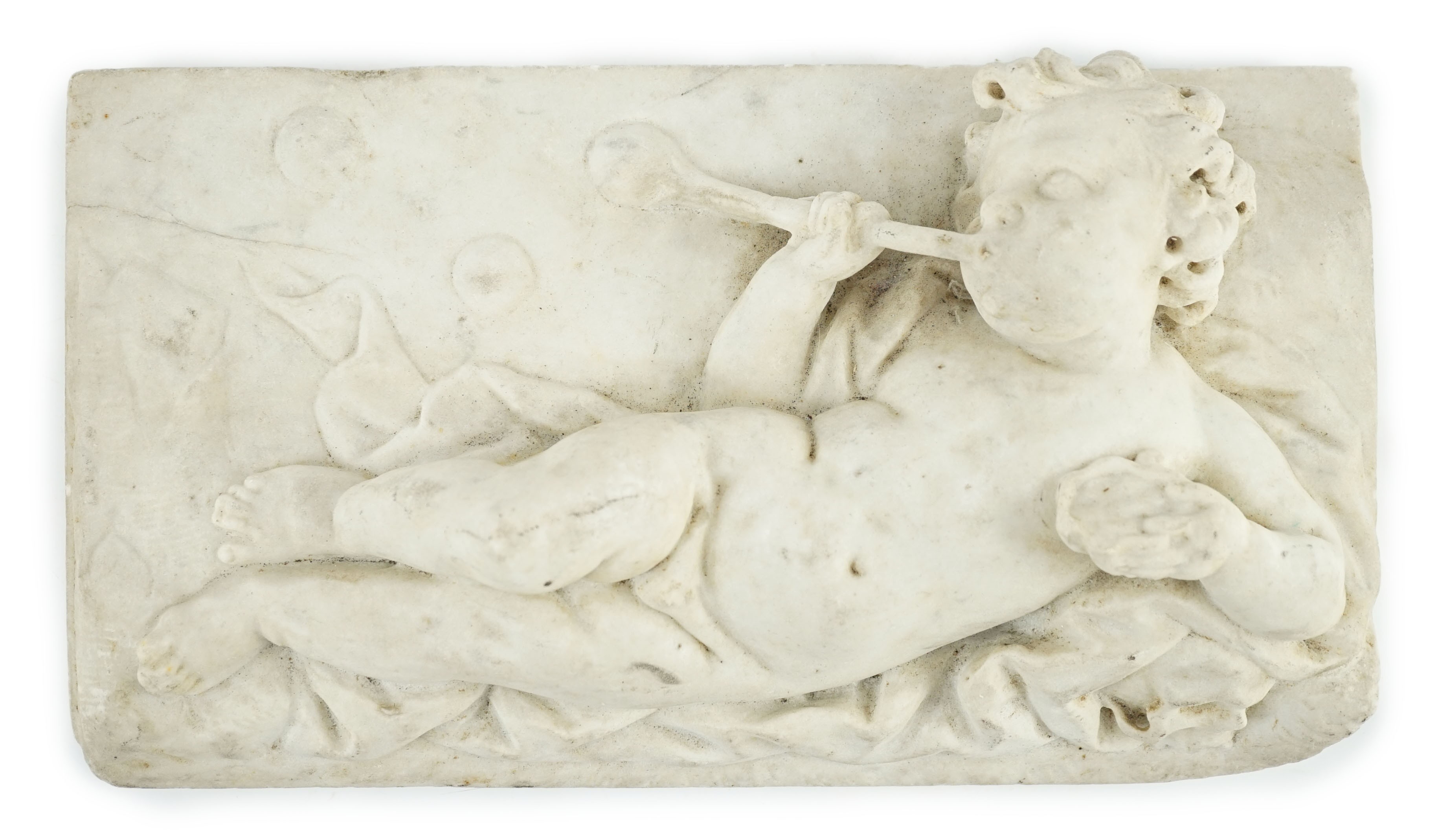 A 17th/18th century Italian marble plaque carved with a reclining cherub, 19.5 x 34.5cm